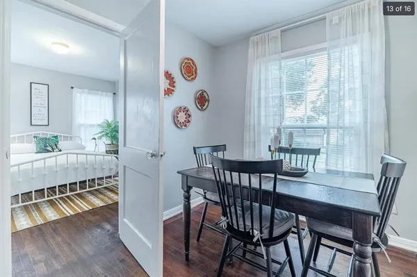 a view of a dining room with furniture a chandelier and wooden floor