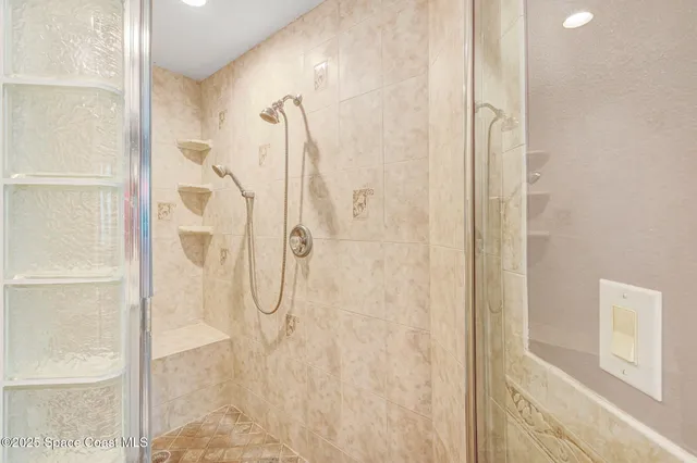 a bath room with a bed and a large mirror