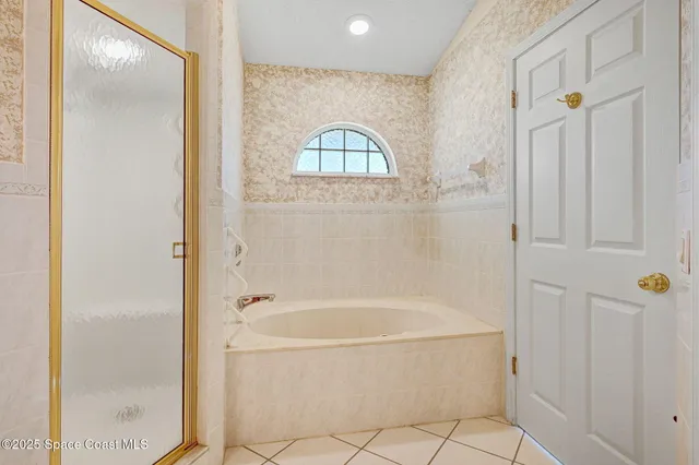 a spacious bathroom with a mirror a shower and a sink