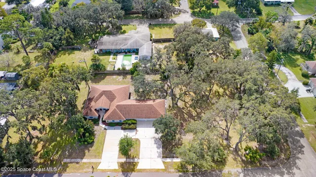 an aerial view of a house with a yard