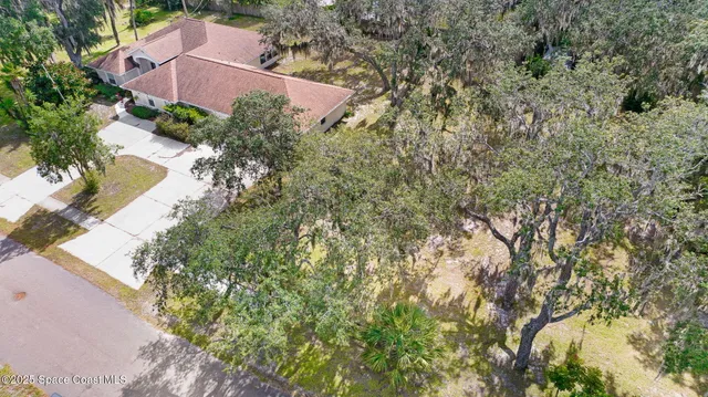 an aerial view of a house with a garden