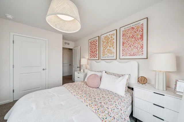 a bedroom with a bed and a lamp on table