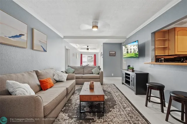 a living room with furniture wooden floor and a window