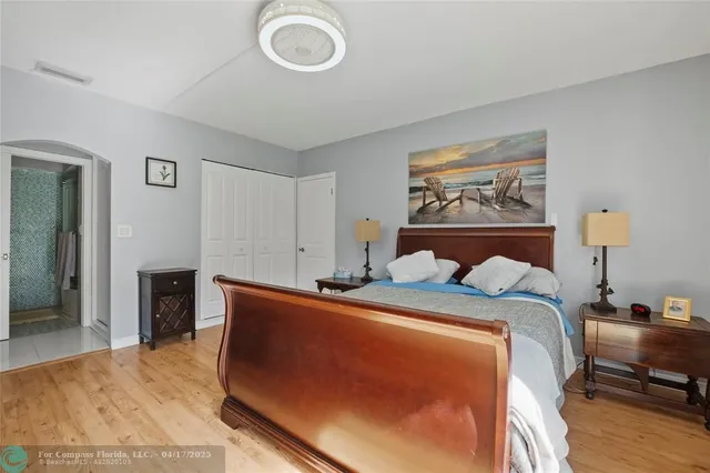 a bedroom with a bed and a lamp on table