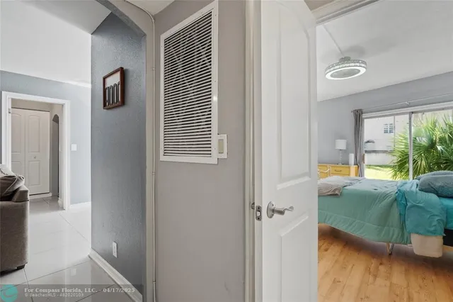 a view of an entryway with wooden floor and a livingroom