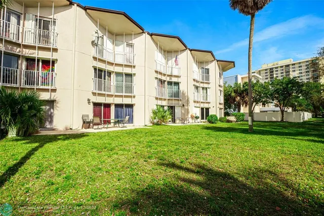 a view of an apartment with a backyard