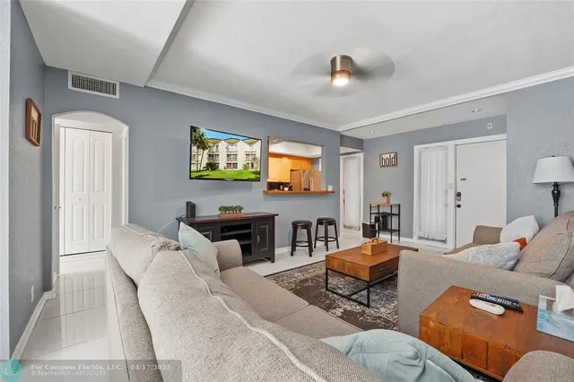 a living room with furniture a large window and a flat screen tv