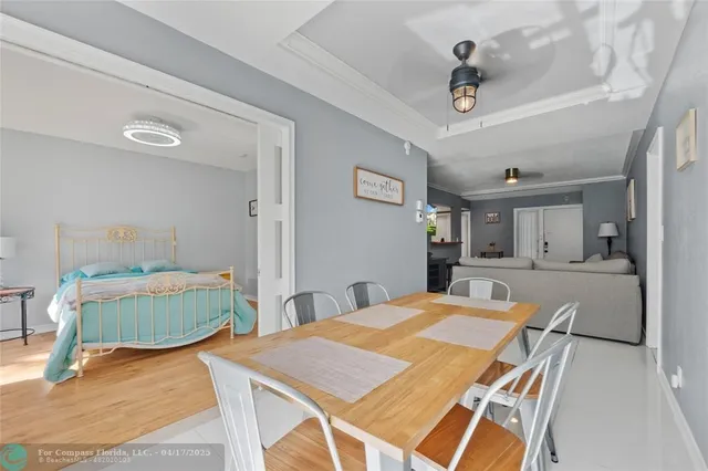 a dining hall with a dining table and chairs with wooden floor