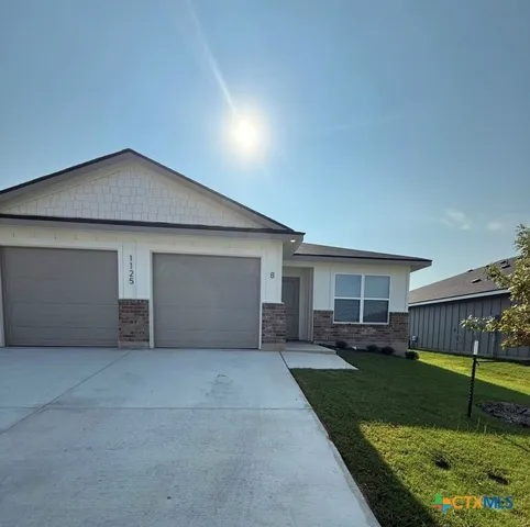 a view of a house with a yard and plants