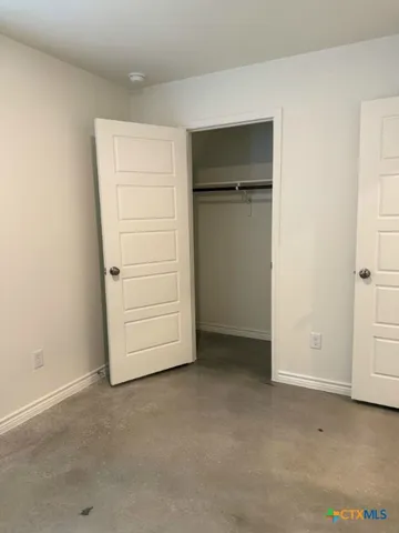 a view of hallway with stairs and wooden floor