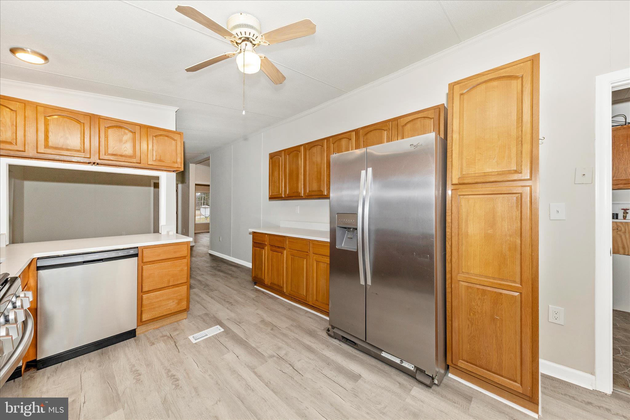 2311 Back Road Sharpsburg, MD 21782 - Photo 11 of 36 a kitchen with stainless steel appliances granite countertop a refrigerator a stove and a sink with wooden floor