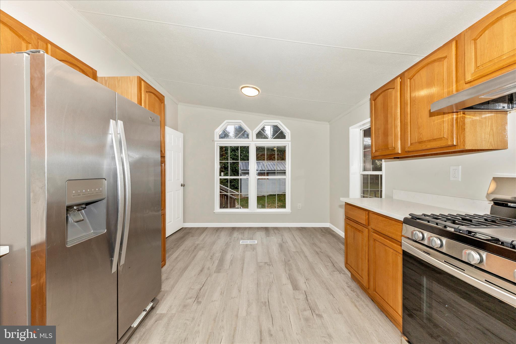 2311 Back Road Sharpsburg, MD 21782 - Photo 13 of 36 a view of a kitchen with wooden floor and stainless steel appliances