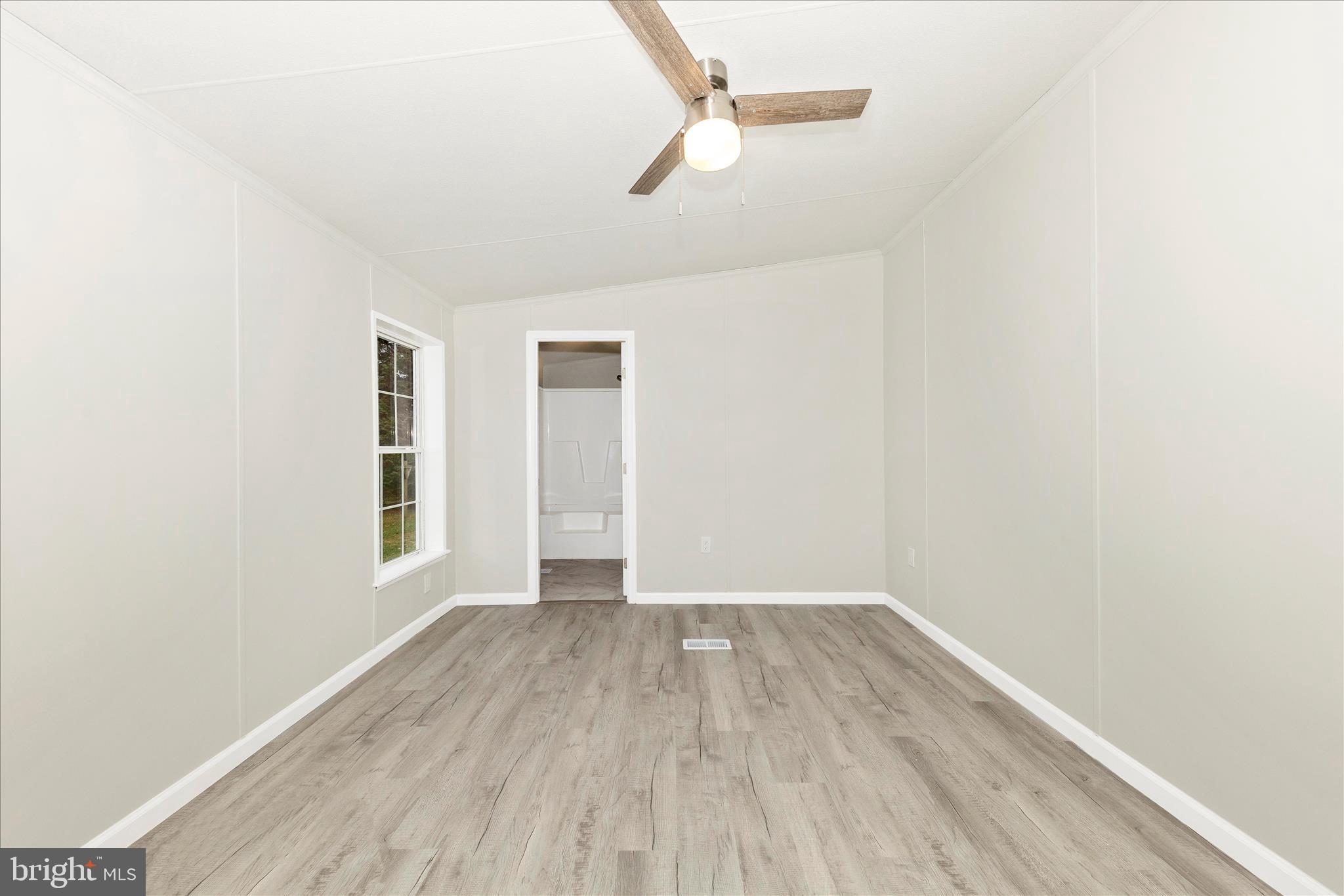 2311 Back Road Sharpsburg, MD 21782 - Photo 16 of 36 a view of an empty room with wooden floor and a window