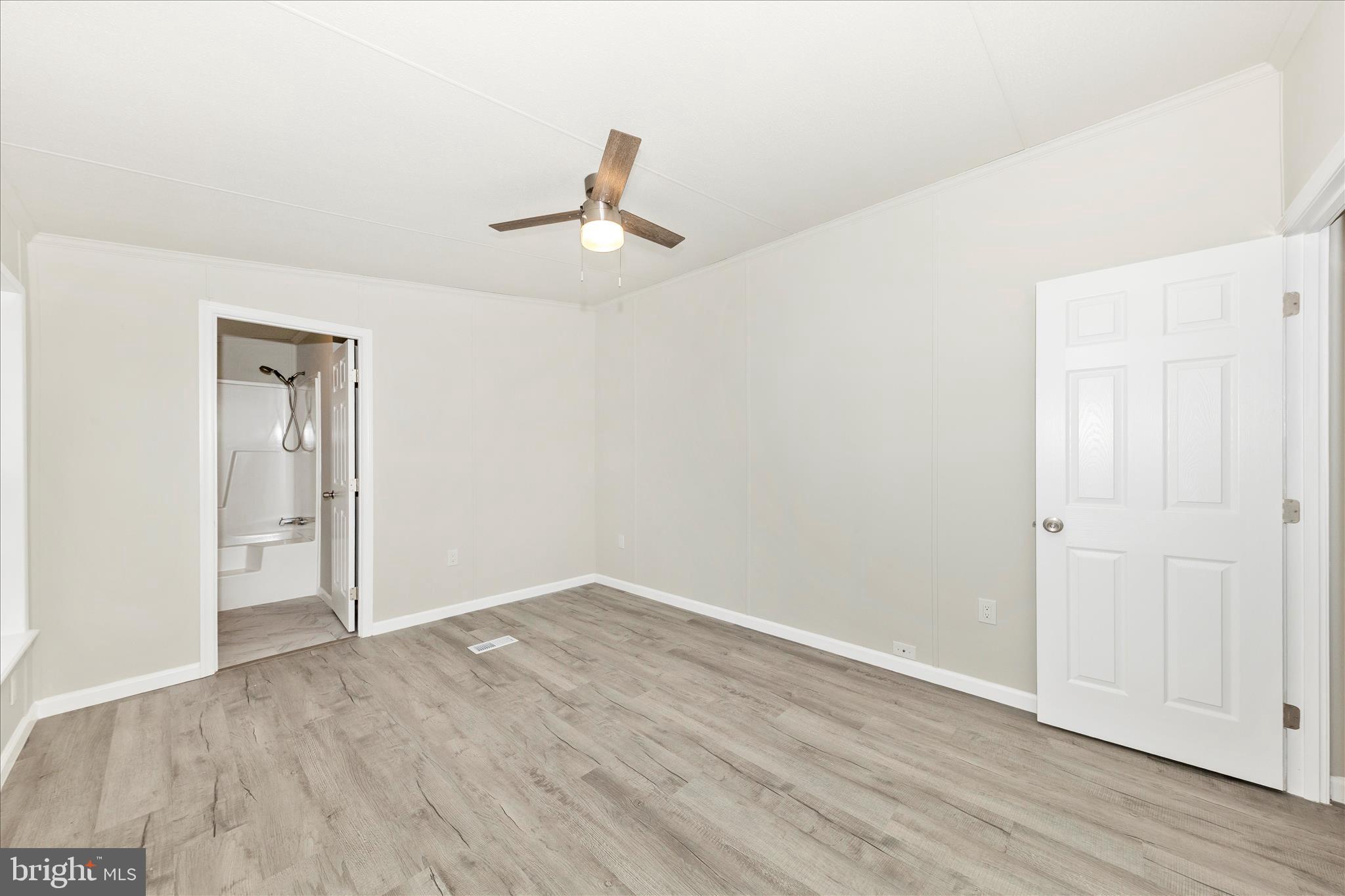2311 Back Road Sharpsburg, MD 21782 - Photo 17 of 36 an empty room with wooden floor cabinet and ceiling fan