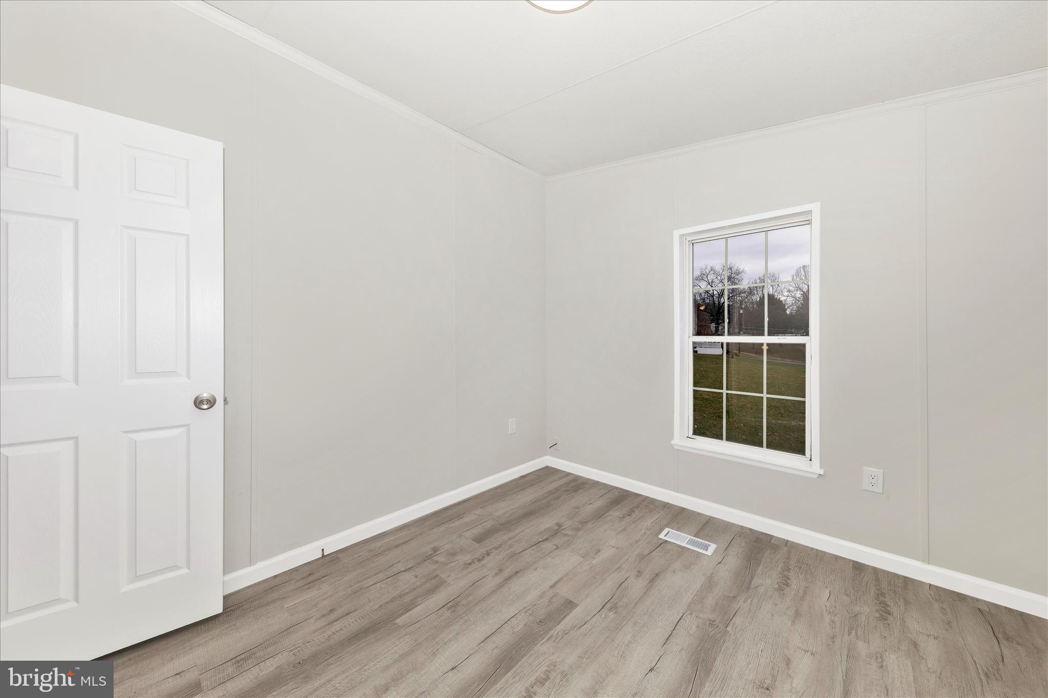 2311 Back Road Sharpsburg, MD 21782 - Photo 25 of 36 an empty room with wooden floor and windows