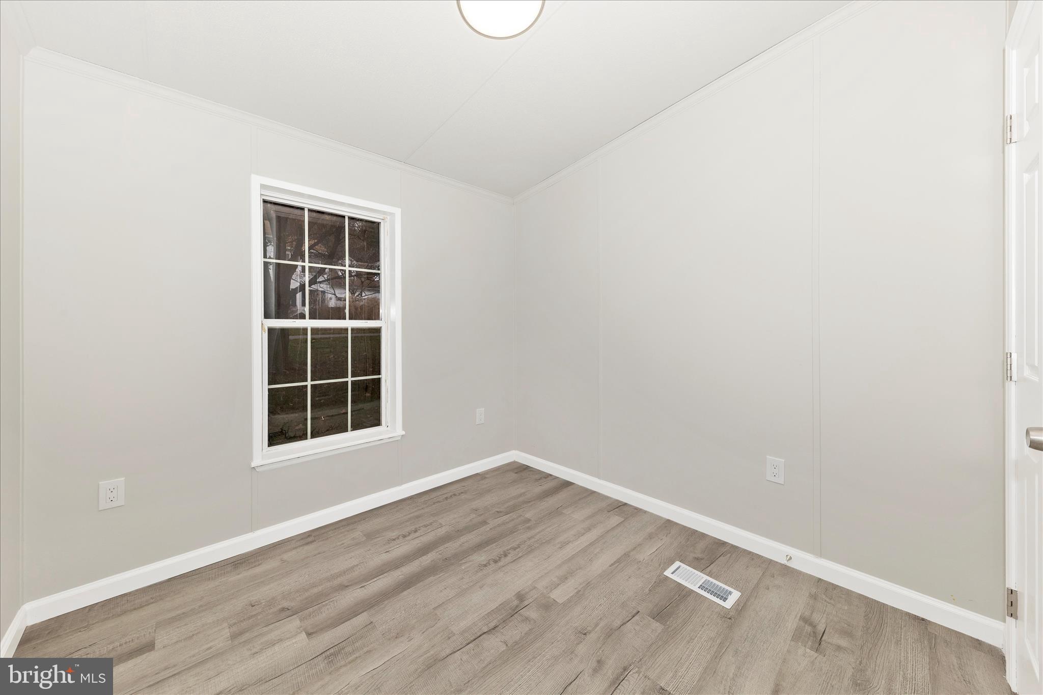 2311 Back Road Sharpsburg, MD 21782 - Photo 26 of 36 an empty room with wooden floor and windows