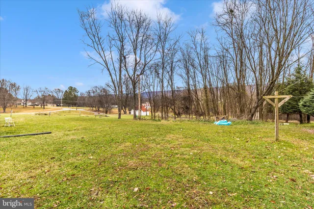 a view of yard with swimming pool and green space