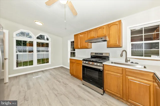 a kitchen with stainless steel appliances granite countertop a stove and a sink