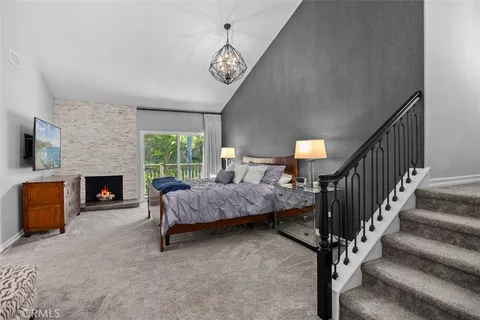 a spacious bedroom with a bed and a fireplace