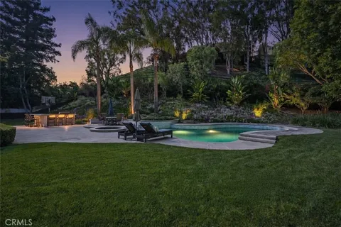 a view of a house with swimming pool and sitting area