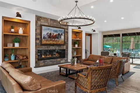 a living room with furniture and a chandelier