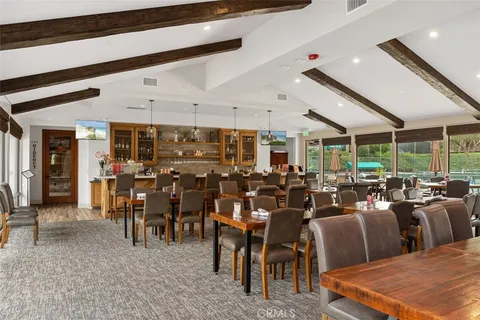 a large room with lots of chairs a table and chairs