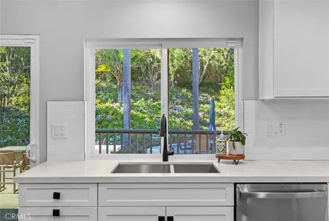 a kitchen with a sink and a large window