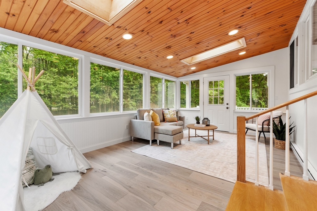 254 Taylor Road Stow, MA 01775 - Photo 11 of 42 a living room with furniture and floor to ceiling windows
