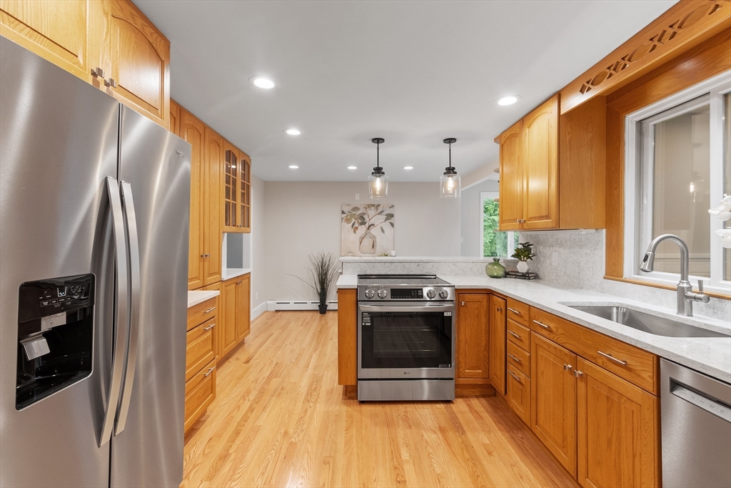 254 Taylor Road Stow, MA 01775 - Photo 19 of 42 a kitchen with stainless steel appliances granite countertop a refrigerator a stove and a sink