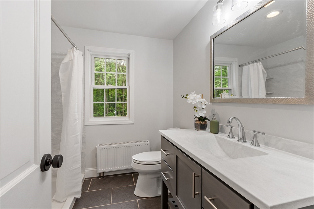 254 Taylor Road Stow, MA 01775 - Photo 28 of 42 a bathroom with a sink toilet and a mirror