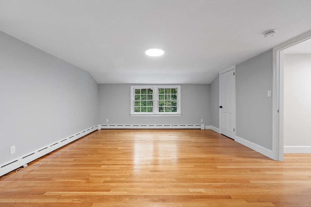 254 Taylor Road Stow, MA 01775 - Photo 30 of 42 a view of an empty room with wooden floor and a window