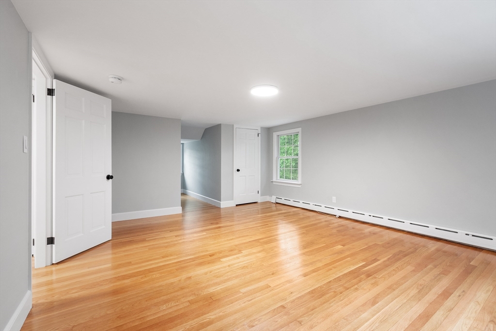 254 Taylor Road Stow, MA 01775 - Photo 33 of 42 a view of an empty room with wooden floor and a window