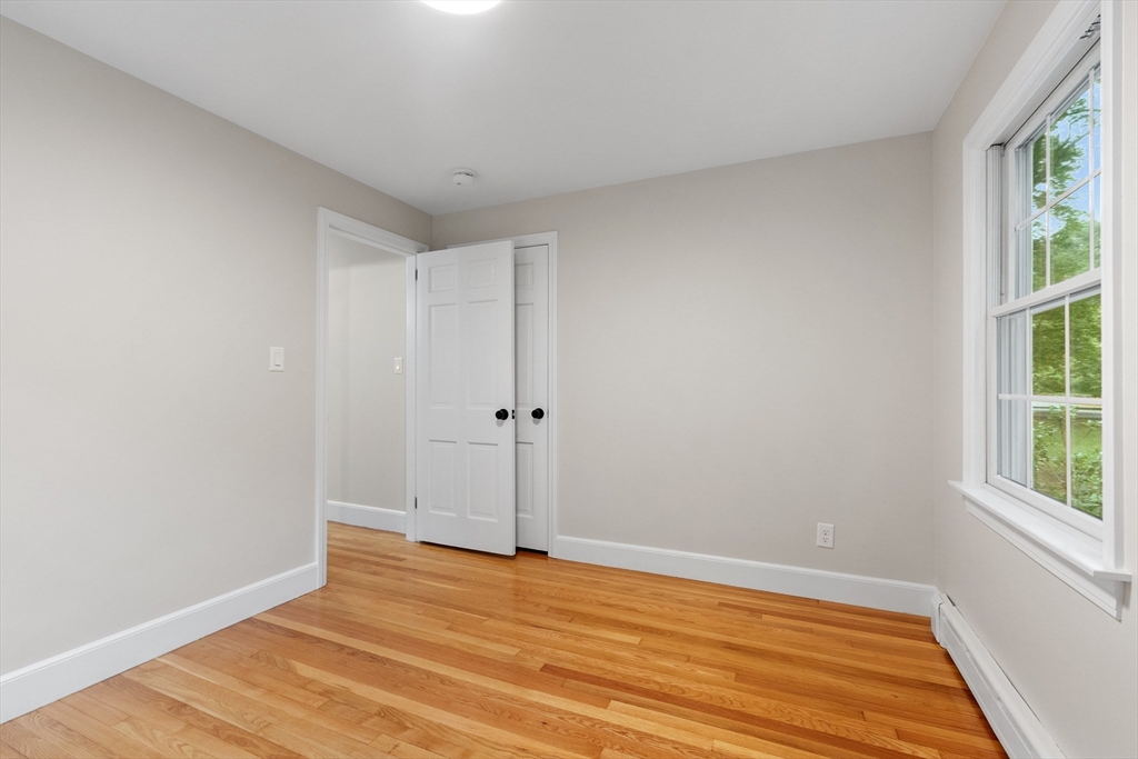 254 Taylor Road Stow, MA 01775 - Photo 34 of 42 a view of an empty room with wooden floor and a window