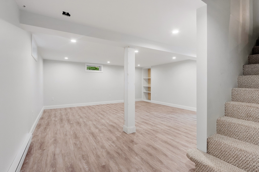 254 Taylor Road Stow, MA 01775 - Photo 36 of 42 a view of a livingroom with wooden floor and staircase