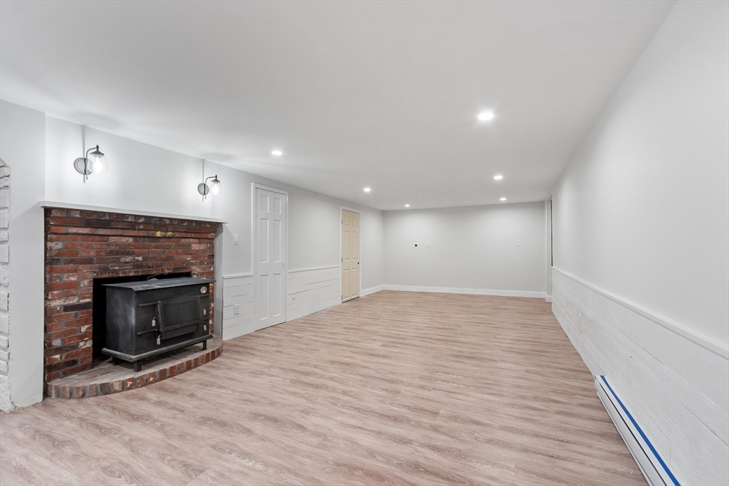254 Taylor Road Stow, MA 01775 - Photo 37 of 42 a view of an empty room with a fireplace