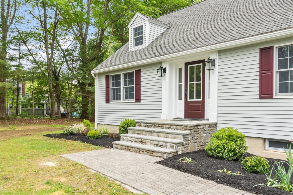 254 Taylor Road Stow, MA 01775 - Photo 7 of 42 a front view of a house with garden