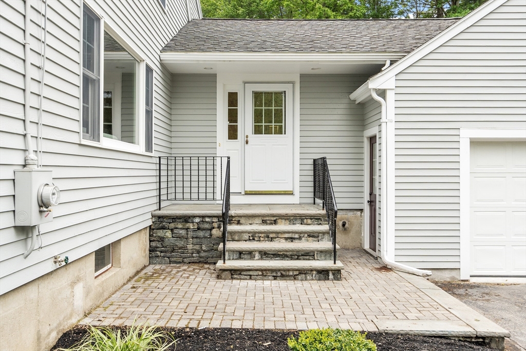 254 Taylor Road Stow, MA 01775 - Photo 8 of 42 a view of a house with a door and a outdoor space