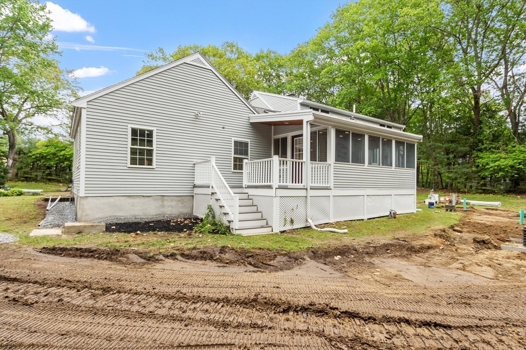254 Taylor Road Stow, MA 01775 - Photo 9 of 42 a view of a house with a yard