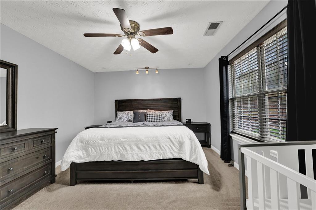 1805 Tribble Ridge Drive Lawrenceville, GA 30045 - Photo 19 of 46 a bedroom with a large bed and a window