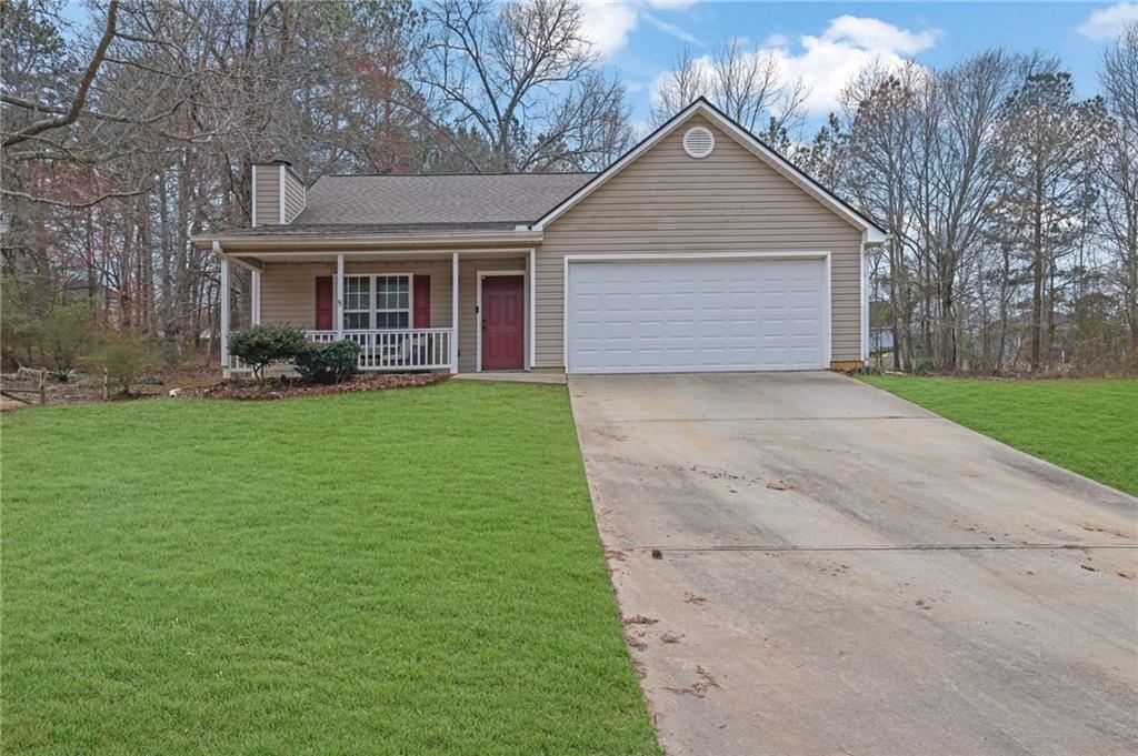 1805 Tribble Ridge Drive Lawrenceville, GA 30045 - Photo 2 of 46 a front view of a house with a yard and garage