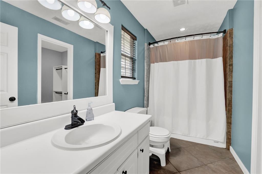 1805 Tribble Ridge Drive Lawrenceville, GA 30045 - Photo 21 of 46 a bathroom with a sink vanity mirror and toilet