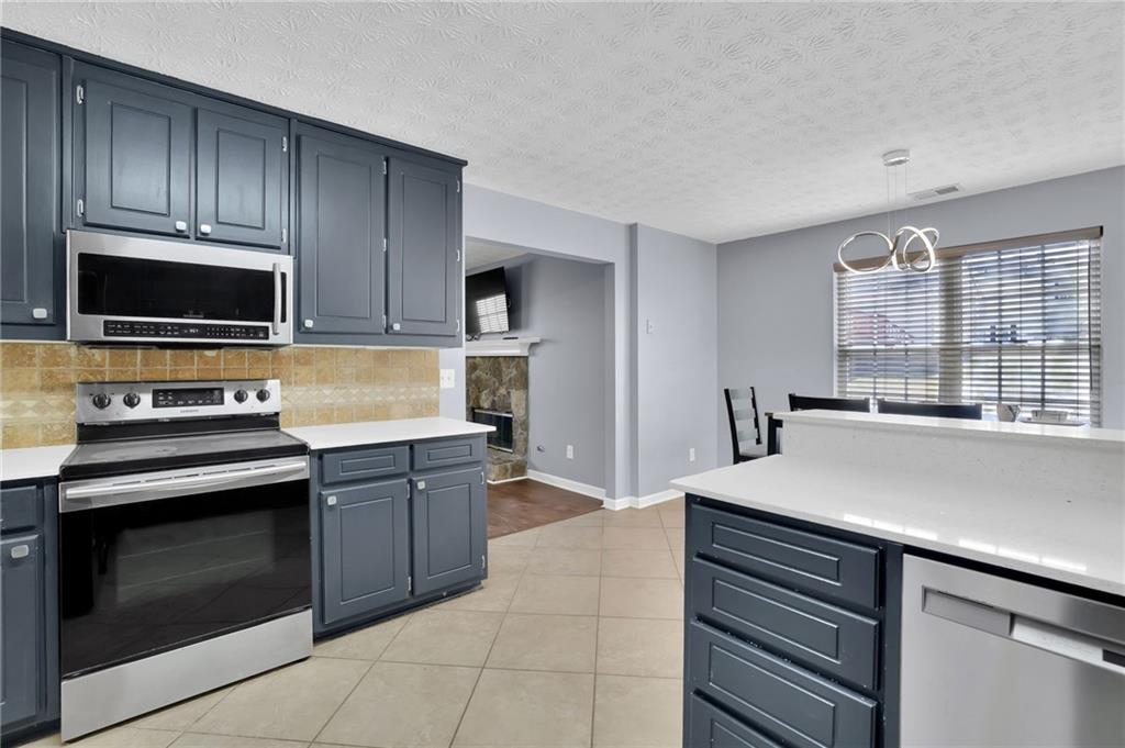 1805 Tribble Ridge Drive Lawrenceville, GA 30045 - Photo 22 of 46 a kitchen with a sink and steel appliances