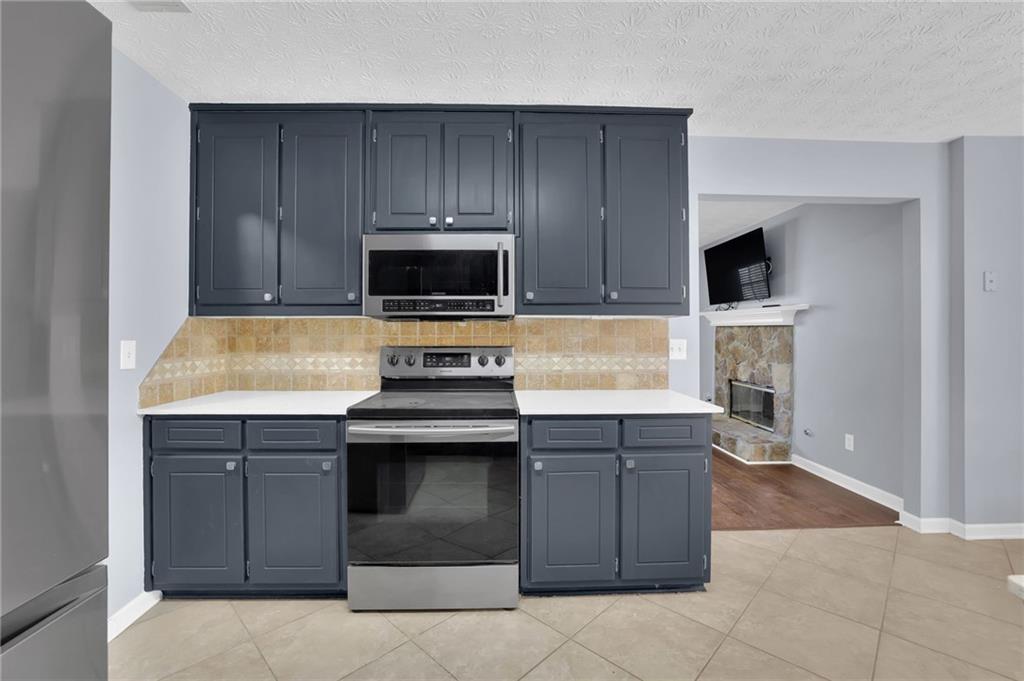 1805 Tribble Ridge Drive Lawrenceville, GA 30045 - Photo 23 of 46 a kitchen with a stove and a microwave