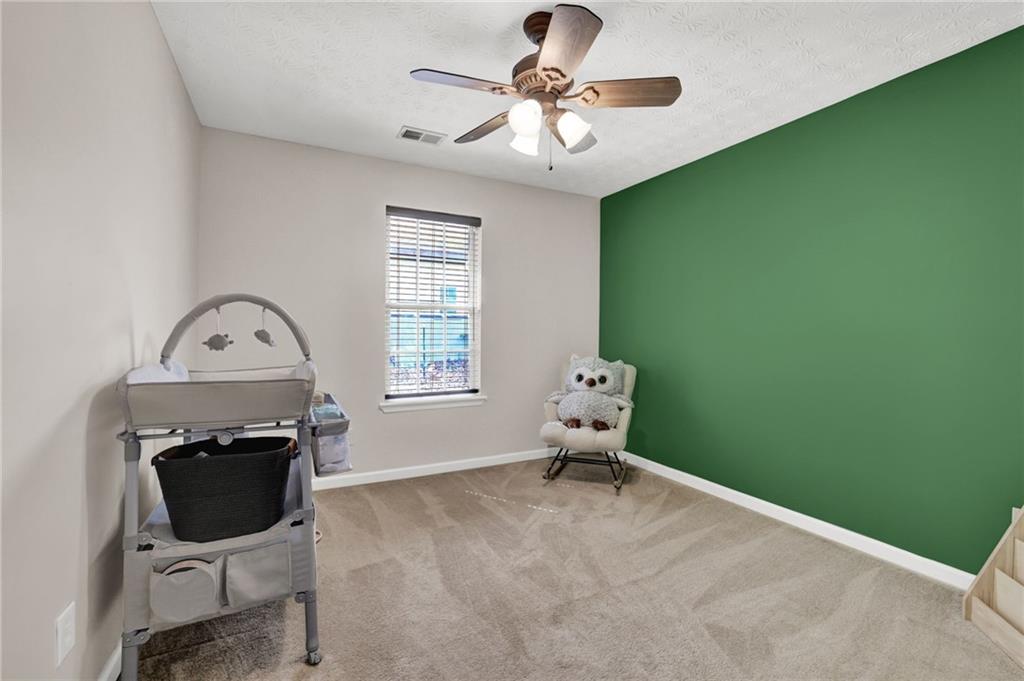 1805 Tribble Ridge Drive Lawrenceville, GA 30045 - Photo 25 of 46 a living room with furniture and a fireplace