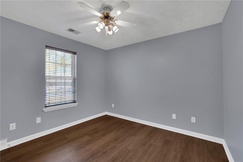 1805 Tribble Ridge Drive Lawrenceville, GA 30045 - Photo 26 of 46 an empty room with wooden floor and windows