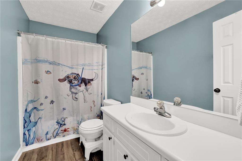 1805 Tribble Ridge Drive Lawrenceville, GA 30045 - Photo 27 of 46 a bathroom with a sink toilet and shower