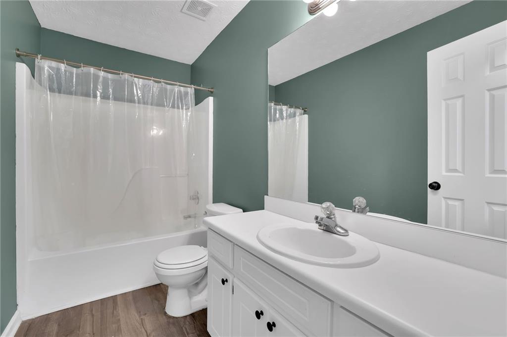 1805 Tribble Ridge Drive Lawrenceville, GA 30045 - Photo 28 of 46 a bathroom with a sink toilet and shower