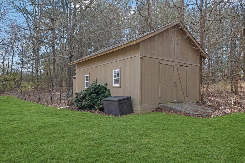 1805 Tribble Ridge Drive Lawrenceville, GA 30045 - Photo 30 of 46 a view of a backyard with potted plants and large tree