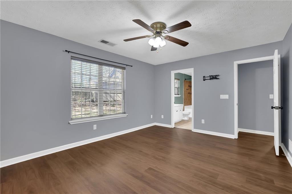 1805 Tribble Ridge Drive Lawrenceville, GA 30045 - Photo 31 of 46 a view of an empty room with wooden floor and a window