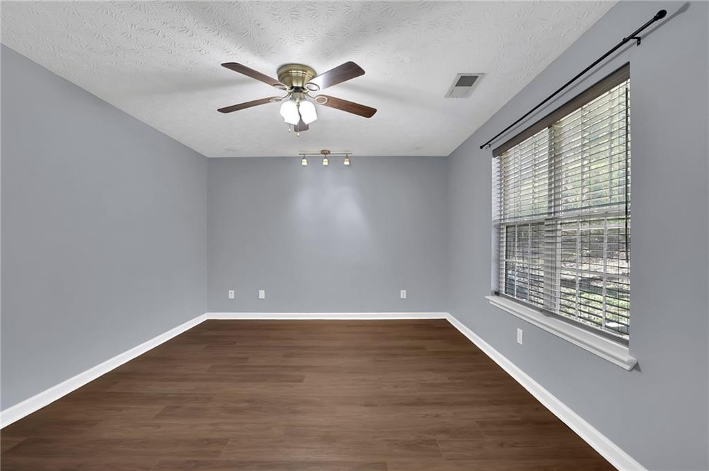 1805 Tribble Ridge Drive Lawrenceville, GA 30045 - Photo 33 of 46 a view of an empty room with wooden floor and a window